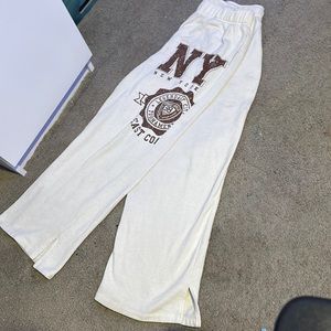White new york sweatpants with cuts in the bottom